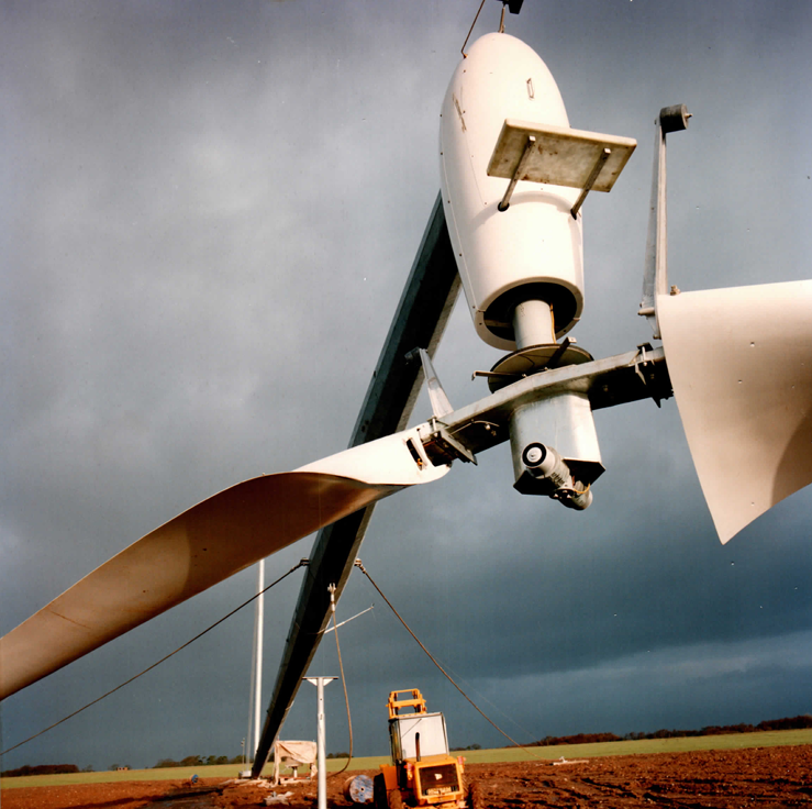 The two-blade teetered hub and nacelle just clear of the ground — the tail boom and instrumentation are already fitted.
