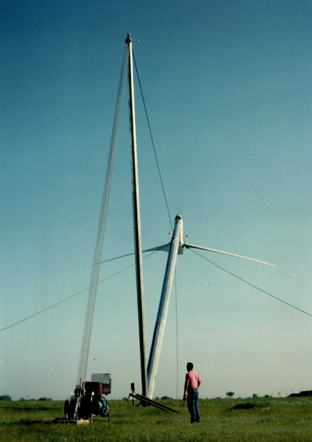 The same tilt-up system deployed in Texas sunshine — one man supervises the winch as the complete machine goes vertical.
