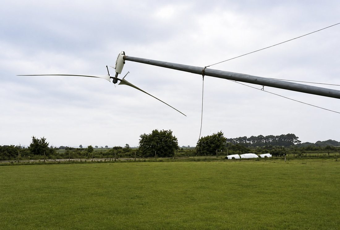 Carter two-blade rotor and nacelle on its lowered guyed tower at the Orton wind farm