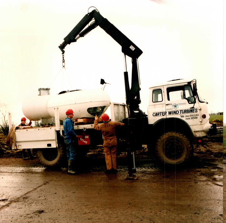 Nacelle delivery by the Carter Wind Turbines service truck — the Atlas crane offloads a nacelle shell at the Great Orton site.